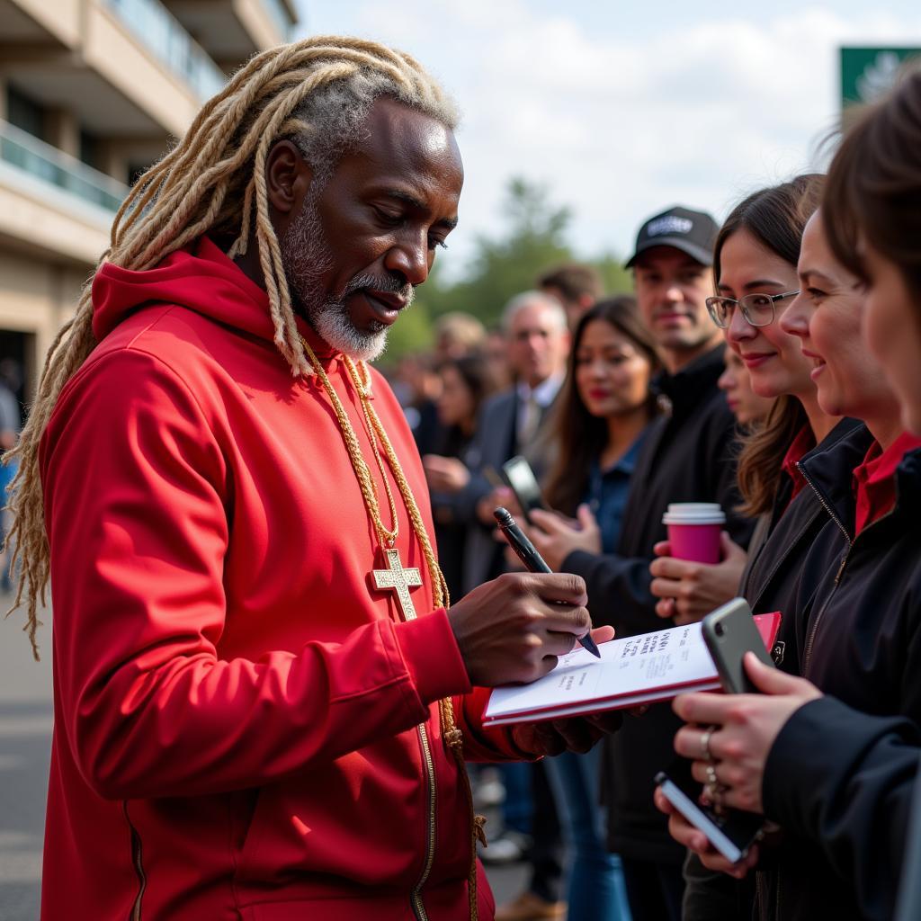 Allan Saint-Maximin interacting with fans, demonstrating his connection with the supporters.